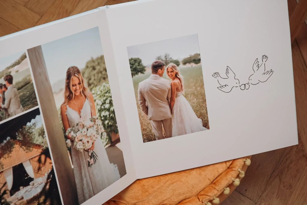 Couple browsing a wedding photo album filled with cherished moments from their special day
