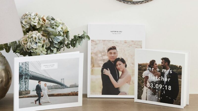 Close-up of elegant wedding album pages showcasing ceremony and reception photographs