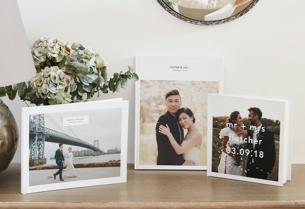 Close-up of elegant wedding album pages showcasing ceremony and reception photographs