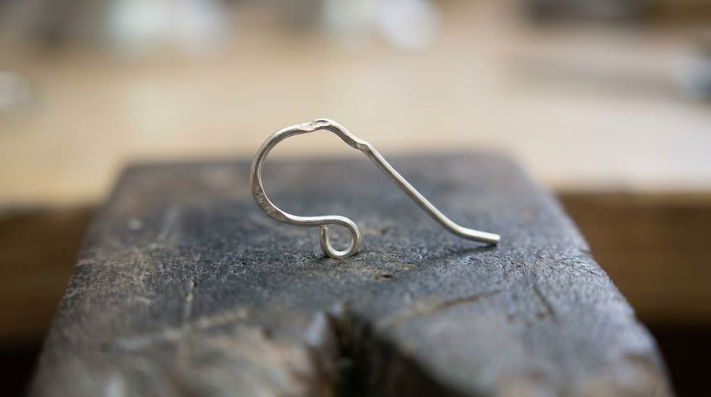 Menkey 925 sterling silver earring hook being repaired with smooth jewelry pliers
