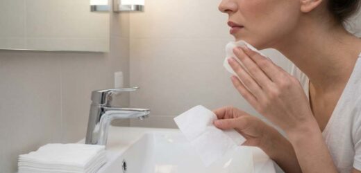 Woman gently using Neutrogena makeup remover wipe on her face